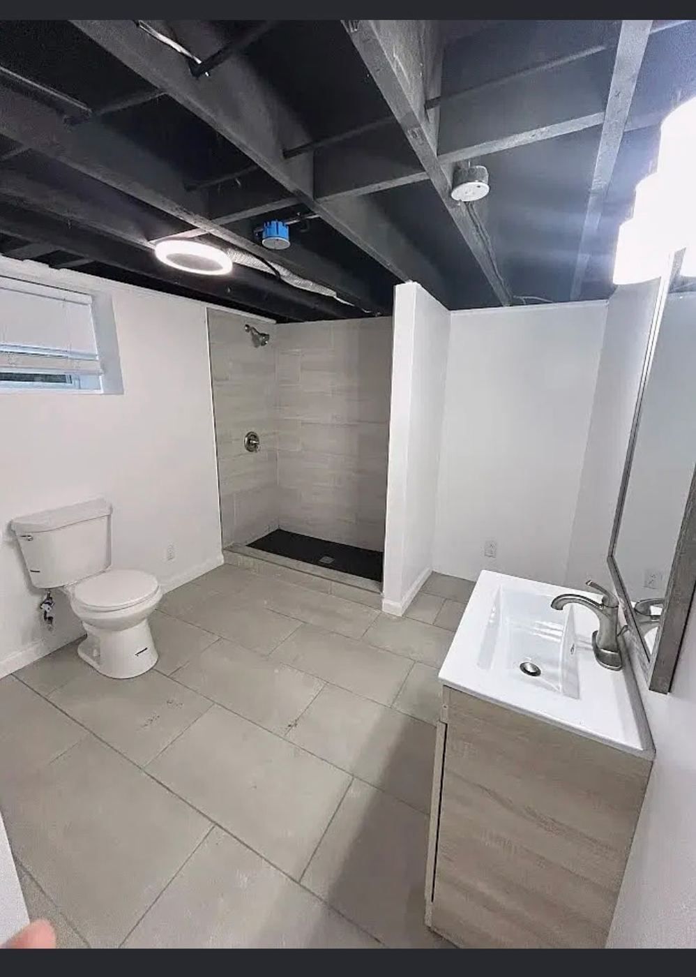 New basement bathroom with a walk-in shower